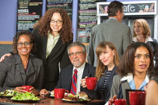 Smiling friends together for lunch in cafeteria