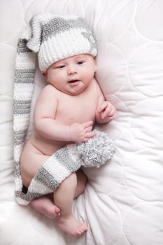 Little baby boy is having a relaxing time on his white blanket