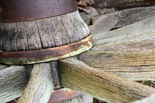 Close up of rustic worn wooden wagon wheel  