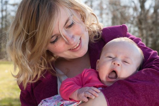 Young mother is having some nice time with her baby on a sunny day