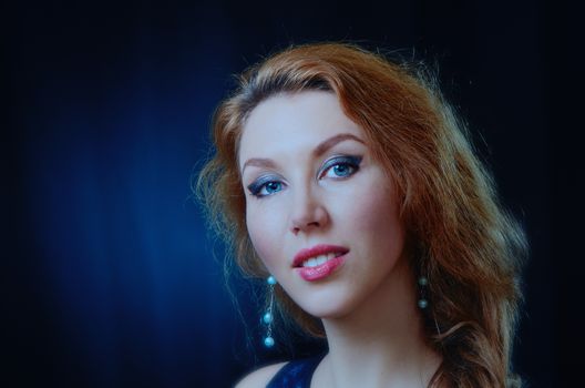 Portrait of young beautiful woman with red hair