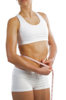 young athletic woman measuring waist measuring tape, isolated on white background