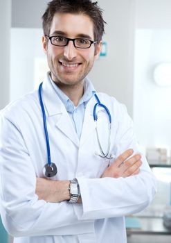 Young professional doctor at hospital with crossed arms