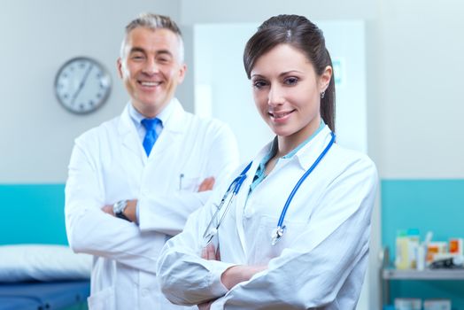 Health care professionals with medical equipment in the background.