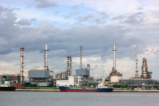 Oil refinery with thunderstorm background