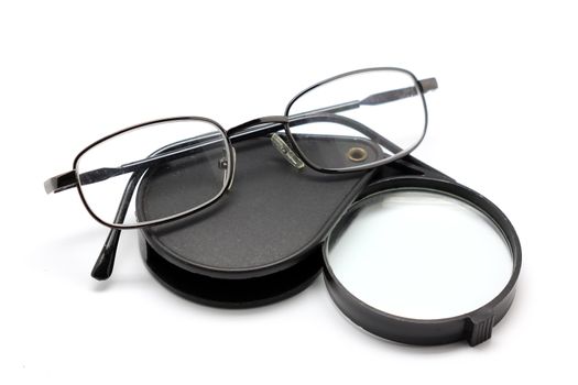 eye glasses and magnifying glass isolated on white background