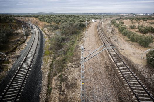 train rails with a city at the background, Jaen, Spain