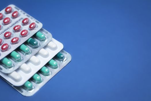 Some pills aligned isolated on blue background