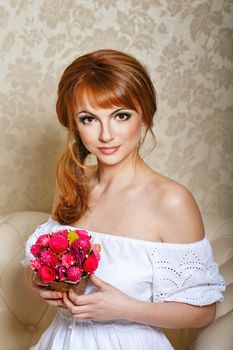 Attractive young bride holding in her hands a bouquet of flowers