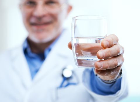Doctor offering a glass of water, healthy lifestyle concept.