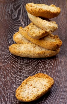 Arrangement of Crispy Whole Wheat Bread Halves closeup on Hardwood background