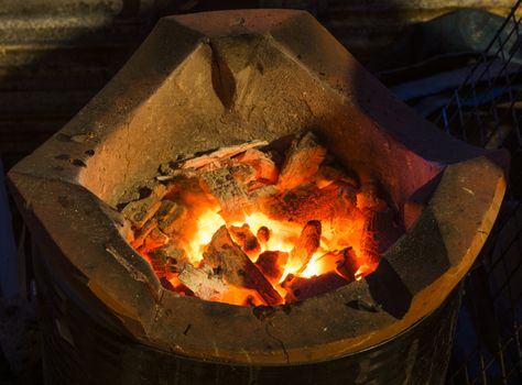 Stove with coals burning down and hot