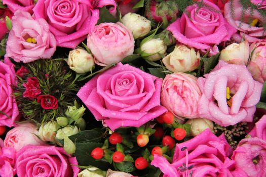 Pink roses and green decorations in a bridal flower arrangement