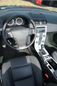 Dashboard and interior of a brand new car, leather and stainless steel