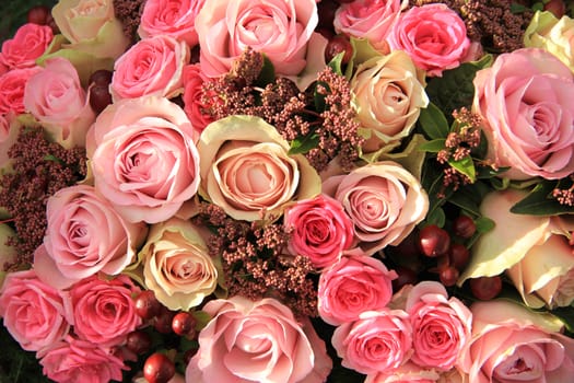 Pastel roses in different shades of pink in a bridal arrangement