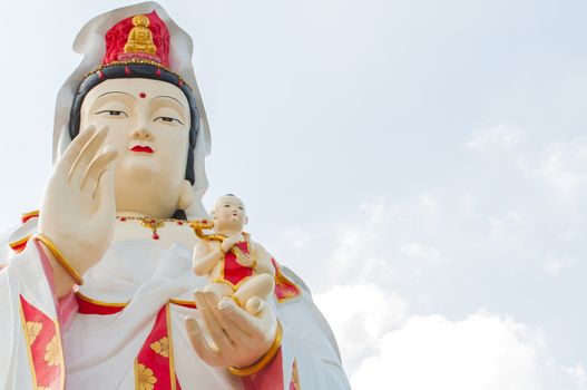 The Guan Yin Buddha Statue child in hand