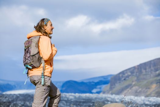 Young woman tourist on the lava field at Landmannalaugar, Iceland
