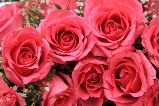 Pink roses in a floral wedding arrangement