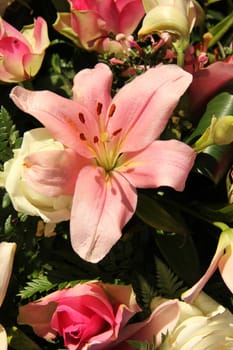 Tigerlily and pink roses in a flower arrangement