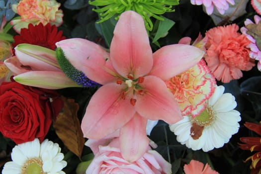 Lilies and roses in a mixed bridal arrangement