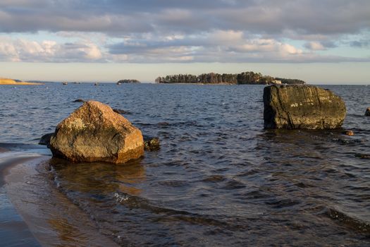 Evening sun in the ocean shore rocks