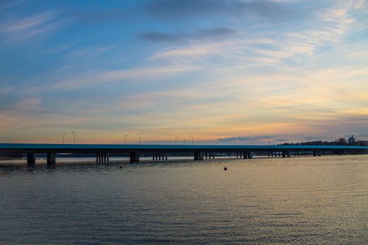 Long bridge over the ocean in the sunset