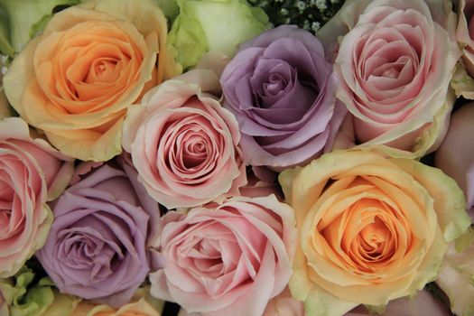 Pastel colored roses in a wedding flower arrangement