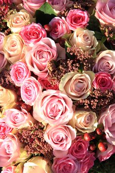 Pastel roses in different shades of pink in a bridal arrangement