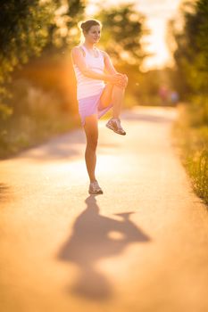 Young woman running outdoors on a lovely sunny summer evening (shallow DOF; color toned image)