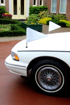 White hearse, funeral service car, on a cemetary