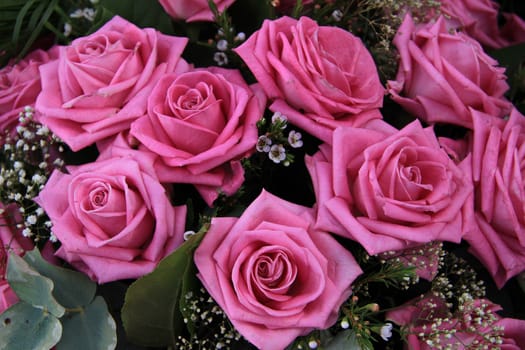 Big pink roses in a wedding bouquet