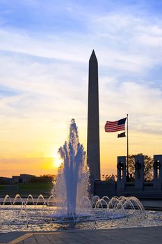A Washington DC sunrise with the World War Two Memorial in the foreground and the Washington Monument in background.