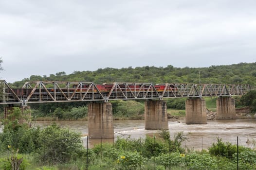 train crossing bridge over elephant riverin south africa near the palce hoedspruit