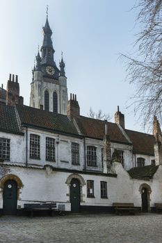 Kortrijk Beguinage and the tower of St. Martin's (Maarten) church. Belgium.