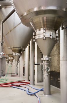 Group of conical, stand-up fermentation tanks as seen at Brewery De Brabandere in Bavikhove, Belgium.