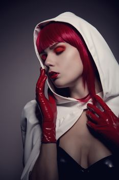 Portrait of mysterious sensual woman wearing white hooded jacket, artistic retro style shot 