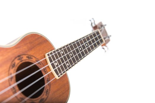 Close-up shot of ukulele guitar, isolated on white background   