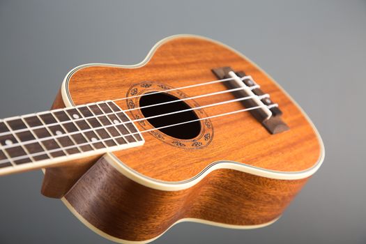 Close-up shot of classic ukulele guitar, selective focus on pattern 