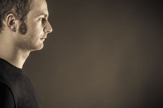 Male portrait on dark background. Close up