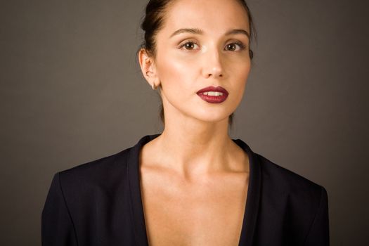 Portrait of a woman on gray background