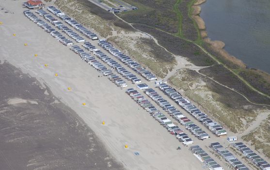 Typical Dutch beachhouses at beach from above, The Netherlands