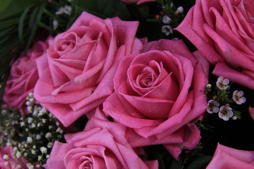 Big pink roses in a wedding bouquet