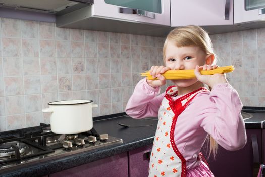 girl with macaroni in the kitchen