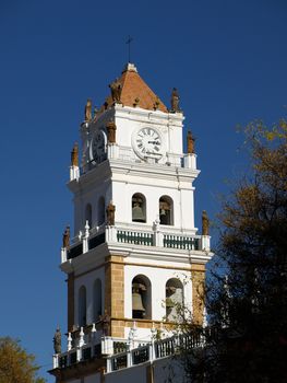 Colonial cathedral tower with clock and bell in Sucre (Bolivia)