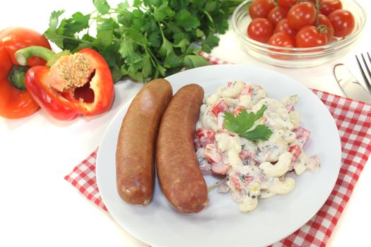 pasta salad and Mettenden with parsley on a light background