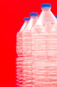 Empty bottles of mineral water with red background
