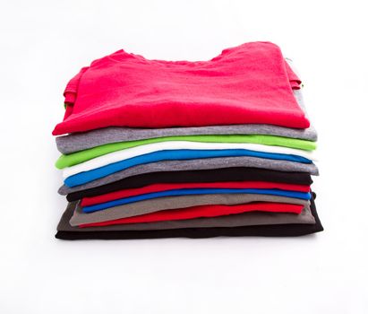 A pile of folded T shirts 

