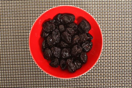 A pile of prunes on a bowl
