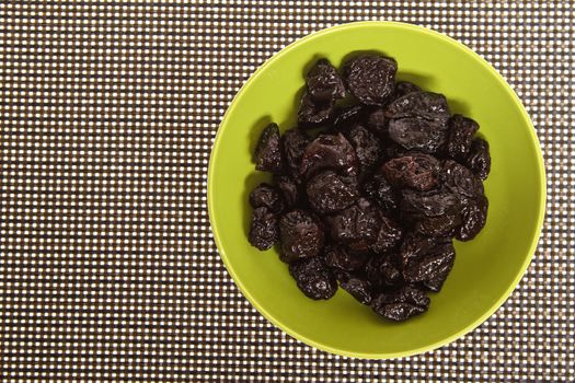 A pile of prunes on a bowl
