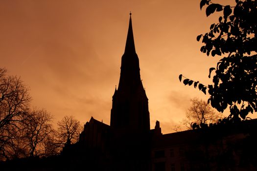Silhouette of church dome in Berlin backlit by sunset colors
